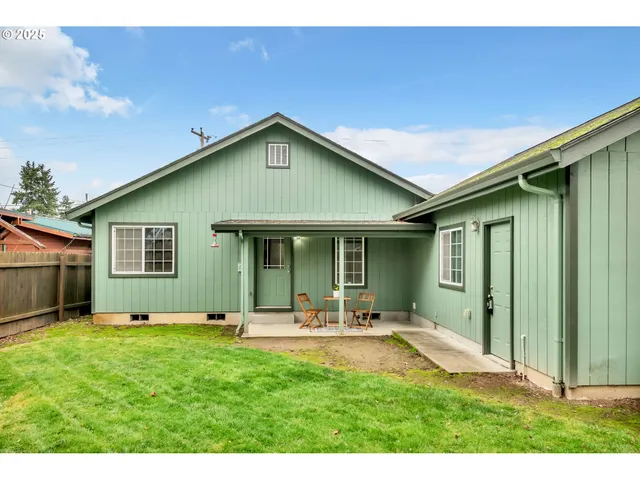 a front view of house with yard and outdoor seating