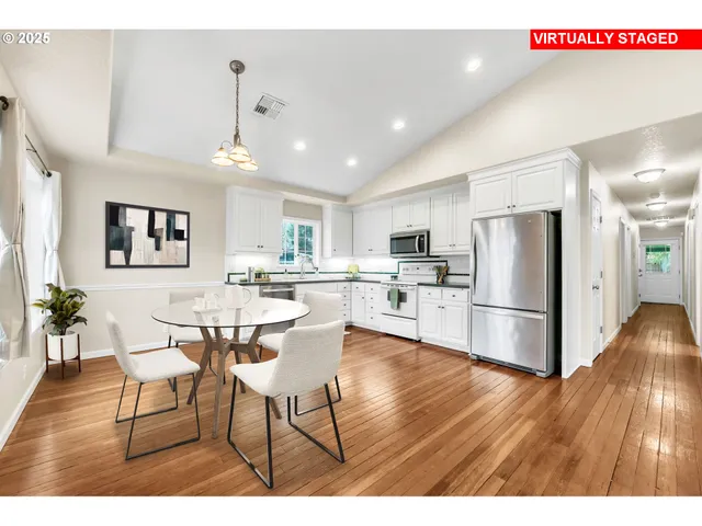 a living room with stainless steel appliances kitchen island granite countertop furniture and wooden floor