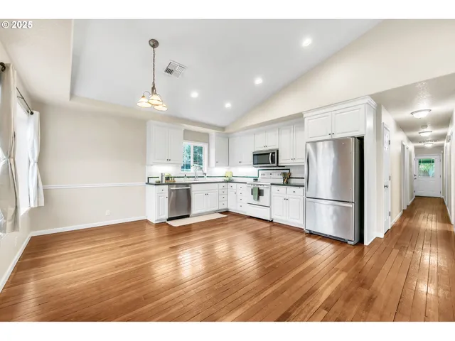 a kitchen with a refrigerator and a sink