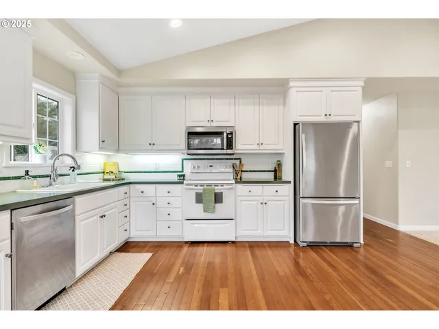 a kitchen with a refrigerator stove and sink