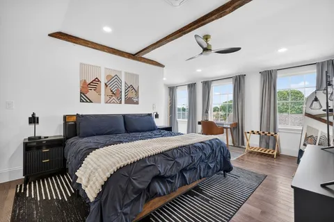 a bedroom with bed and a chandelier