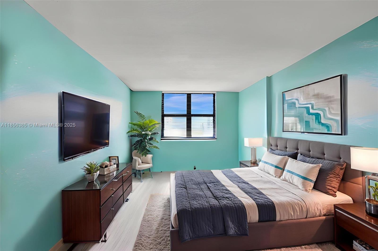 1500 North Ocean Boulevard, Unit 801 Pompano Beach, FL 33062 - Photo 36 of 58 a bedroom with a bed and a flat screen tv