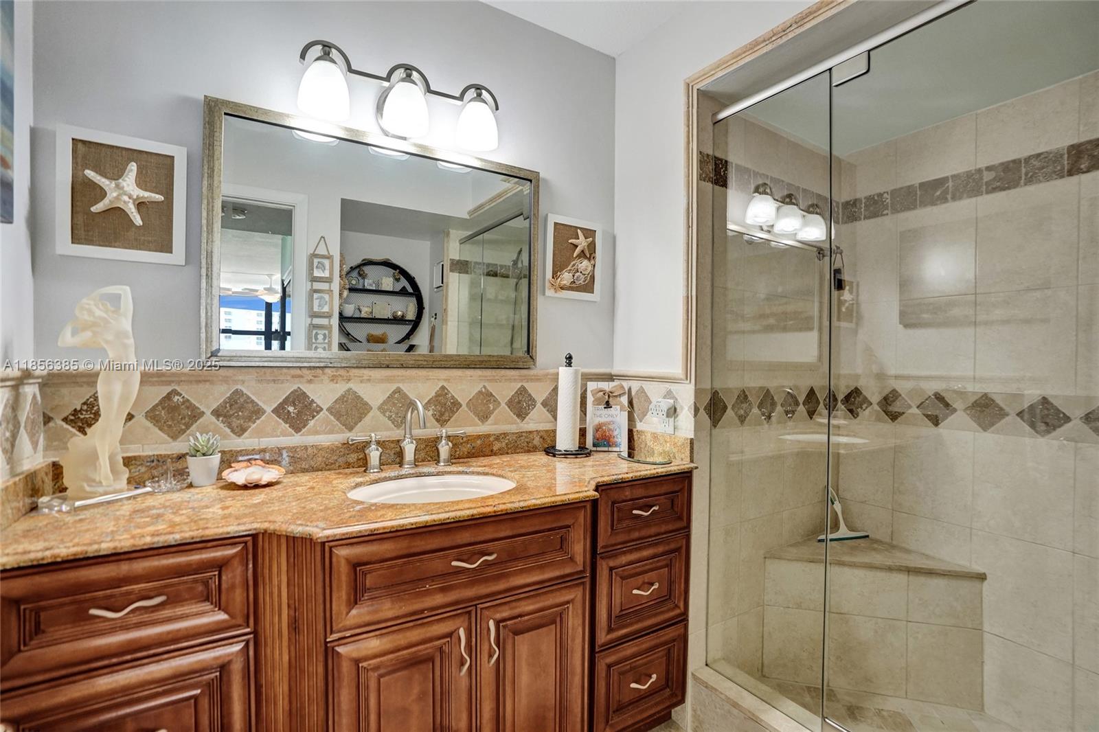 1500 North Ocean Boulevard, Unit 801 Pompano Beach, FL 33062 - Photo 38 of 58 a bathroom with a sink and a mirror