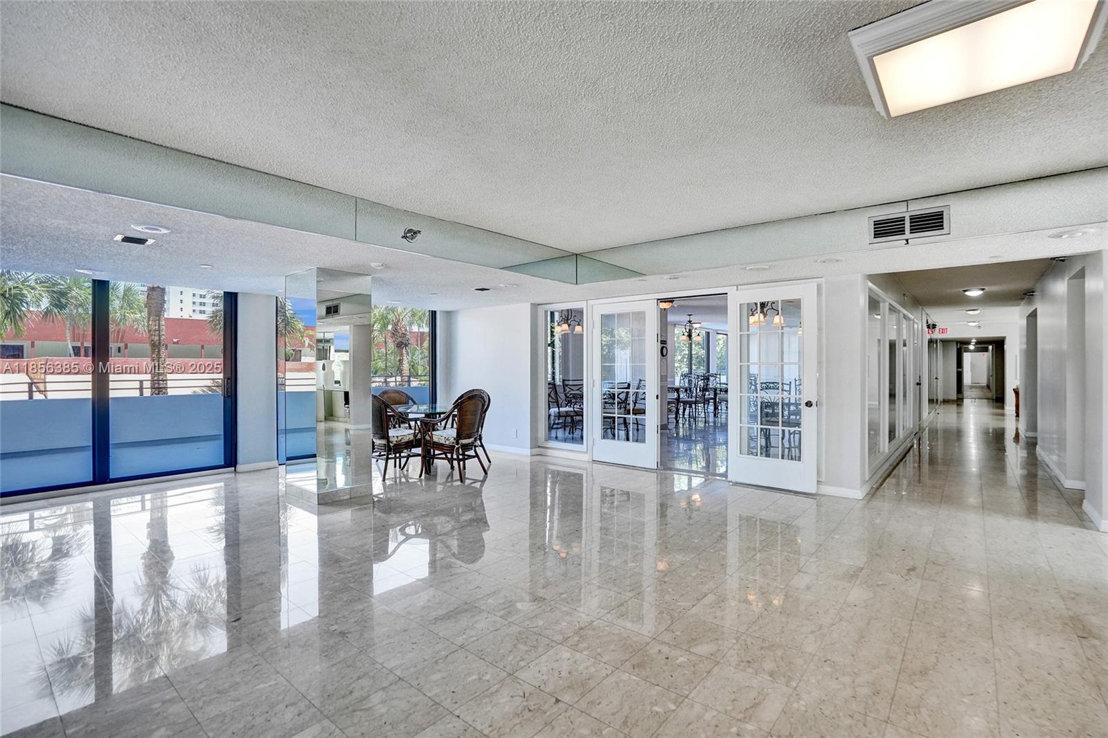 1500 North Ocean Boulevard, Unit 801 Pompano Beach, FL 33062 - Photo 46 of 58 a view of a lobby with furniture and floor to ceiling window