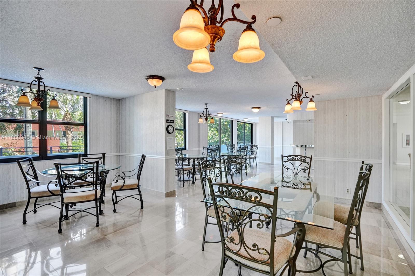 1500 North Ocean Boulevard, Unit 801 Pompano Beach, FL 33062 - Photo 49 of 58 a view of a dining room with furniture and chandelier