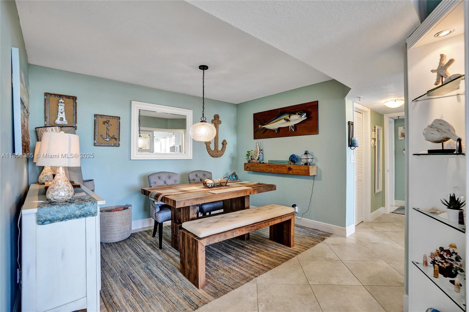1500 North Ocean Boulevard, Unit 801 Pompano Beach, FL 33062 - Photo 9 of 58 a living room with furniture and a flat screen tv