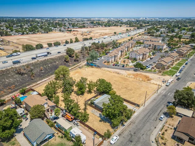 an aerial view of beach and residential houses with outdoor space