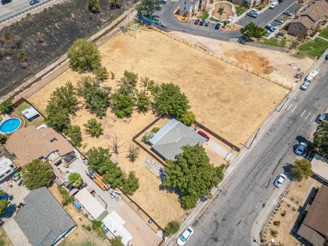 an aerial view of a house with a yard