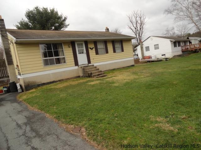 48 Riina Road Wurtsboro, NY 12790 - Photo 2 of 5 a front view of a house with a garden