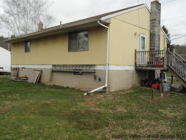 48 Riina Road Wurtsboro, NY 12790 - Photo 5 of 5 a backyard of a house with wooden fence and a table