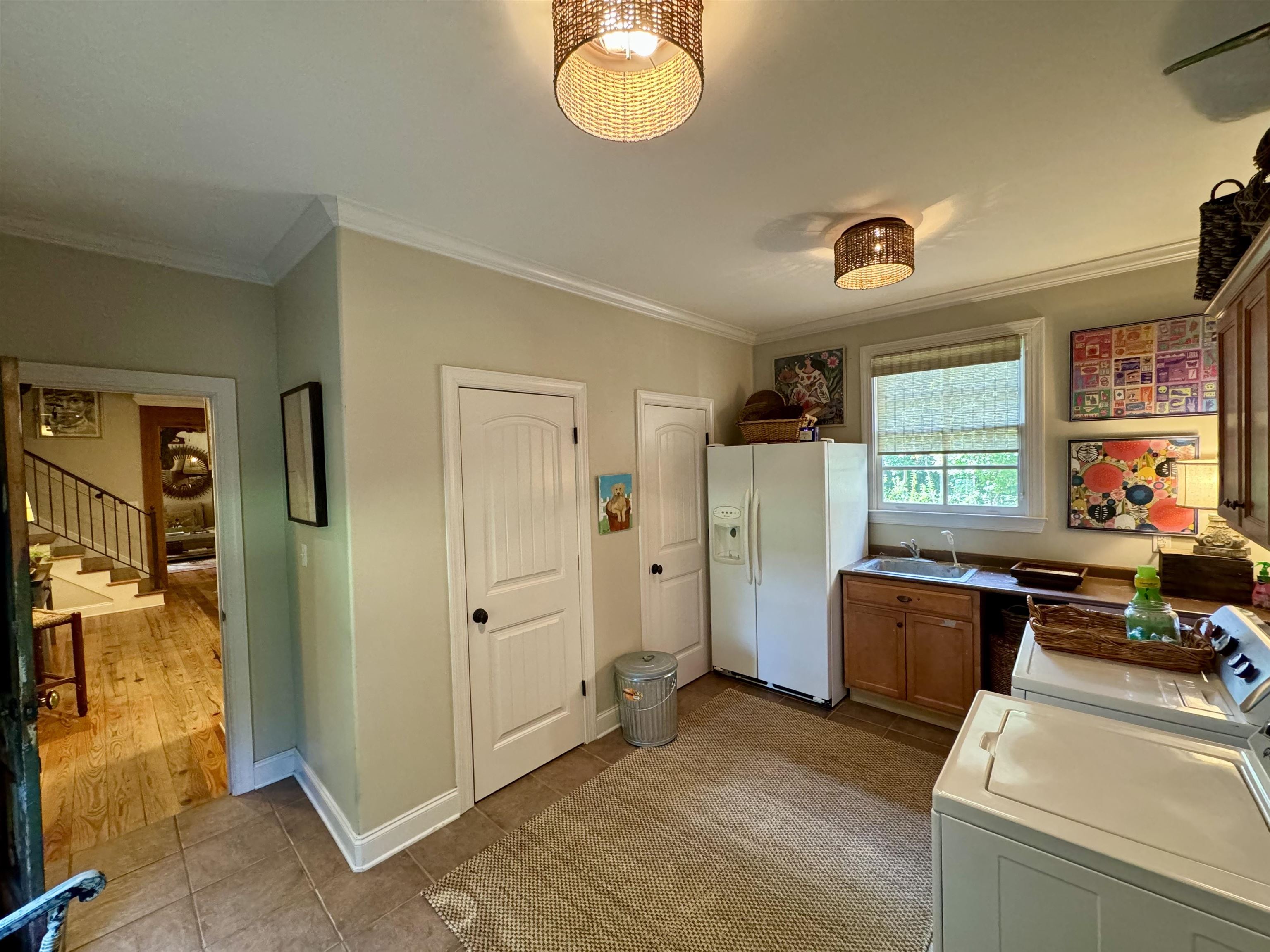 4768 Holly Grove Road Brighton, TN 38011 - Photo 19 of 40 The large Laundry Room (15x12 in size) has a 1/2 bath and closet (where one of the two water heaters is located), as well as ample room for a second frige/freezer, a work sink and a counter for folding clothes.