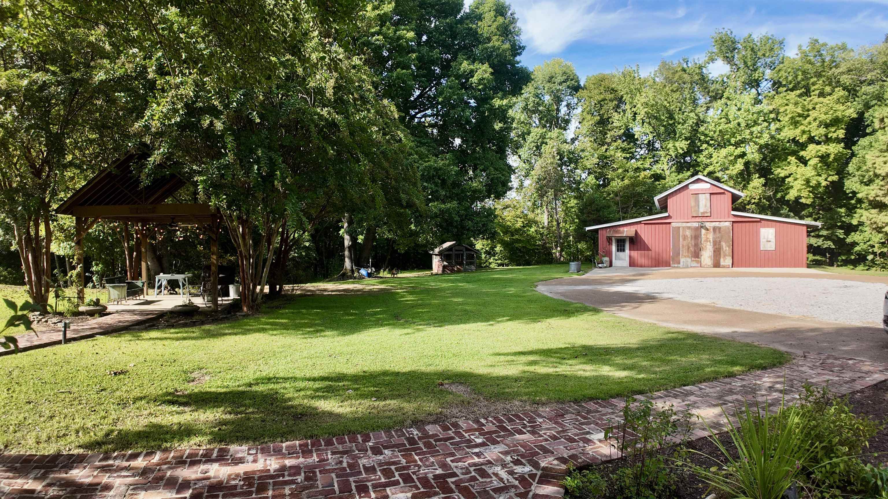 Owner uses the left side of the barn for her at-home business. There's a window unit in this area, as well as running water at the sink. The middle/right areas are perfect for storage, with the area on the right having a roll-up door. Floored loft above.