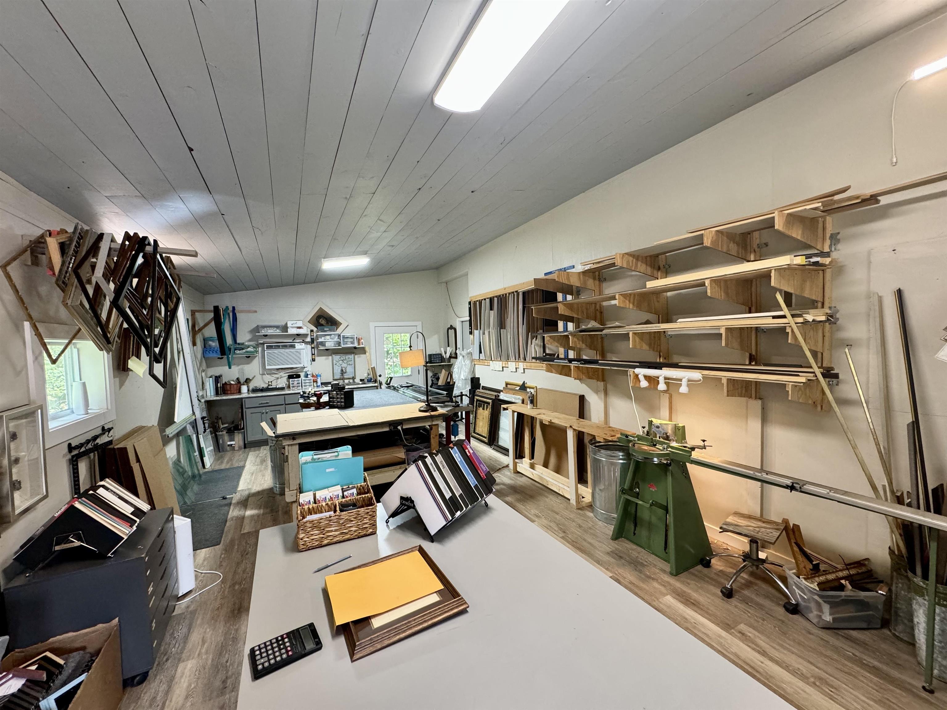 This space is where the current owner works. While there is no restroom here, there is a sink w/water for easy clean-up. There is also a window unit in this space that sells w/the house.