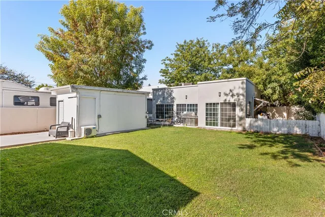 a backyard of a house with table and chairs