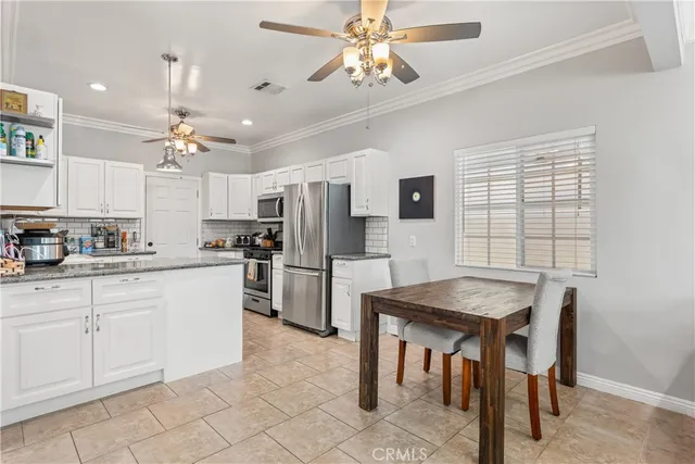 a kitchen with refrigerator cabinets dining table and chairs