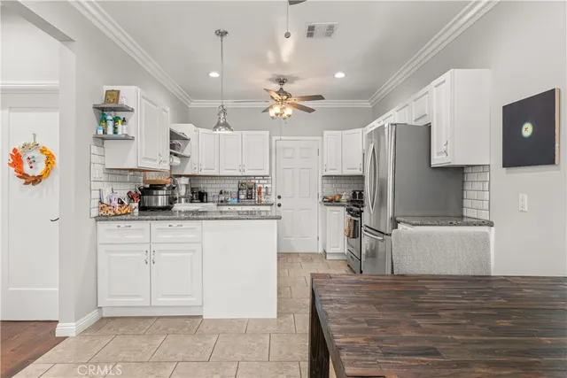 a kitchen with kitchen island a sink stainless steel appliances and cabinets