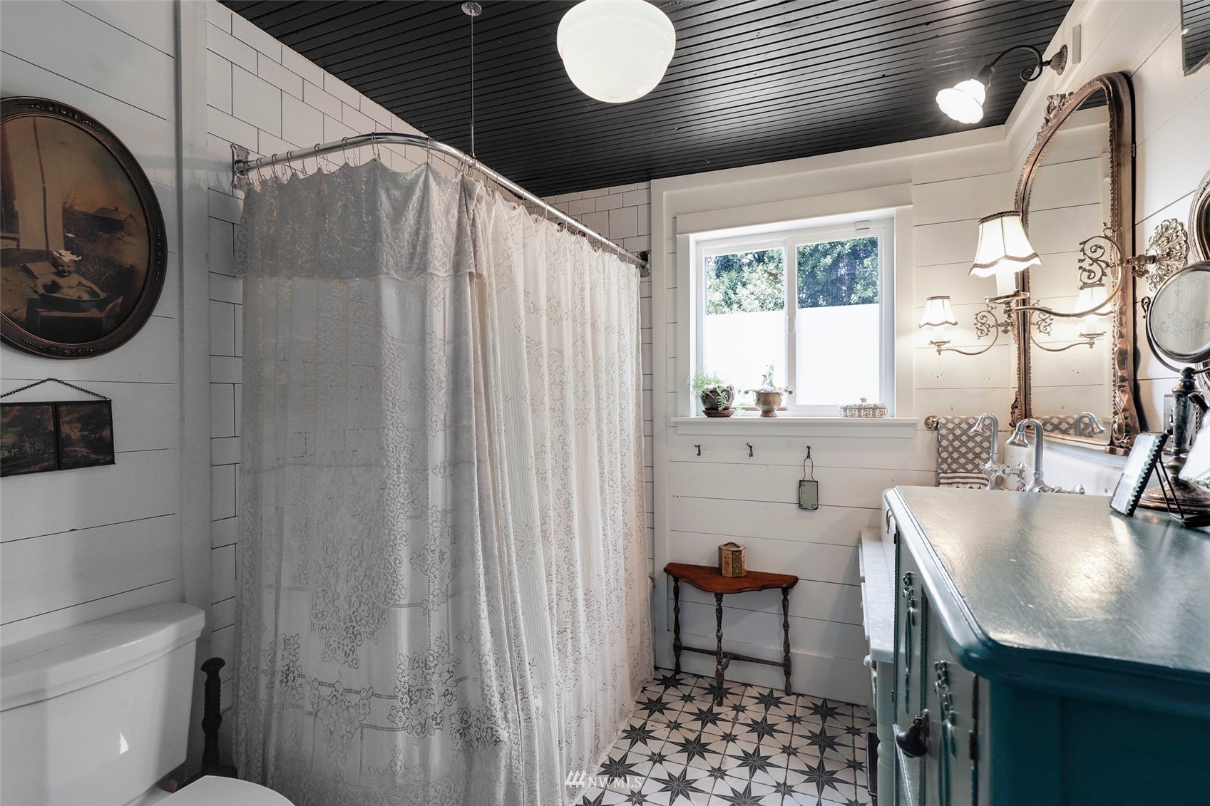 1010 South Director Street Seattle, WA 98108 - Photo 15 of 40 a bathroom with a sink a mirror and a toilet