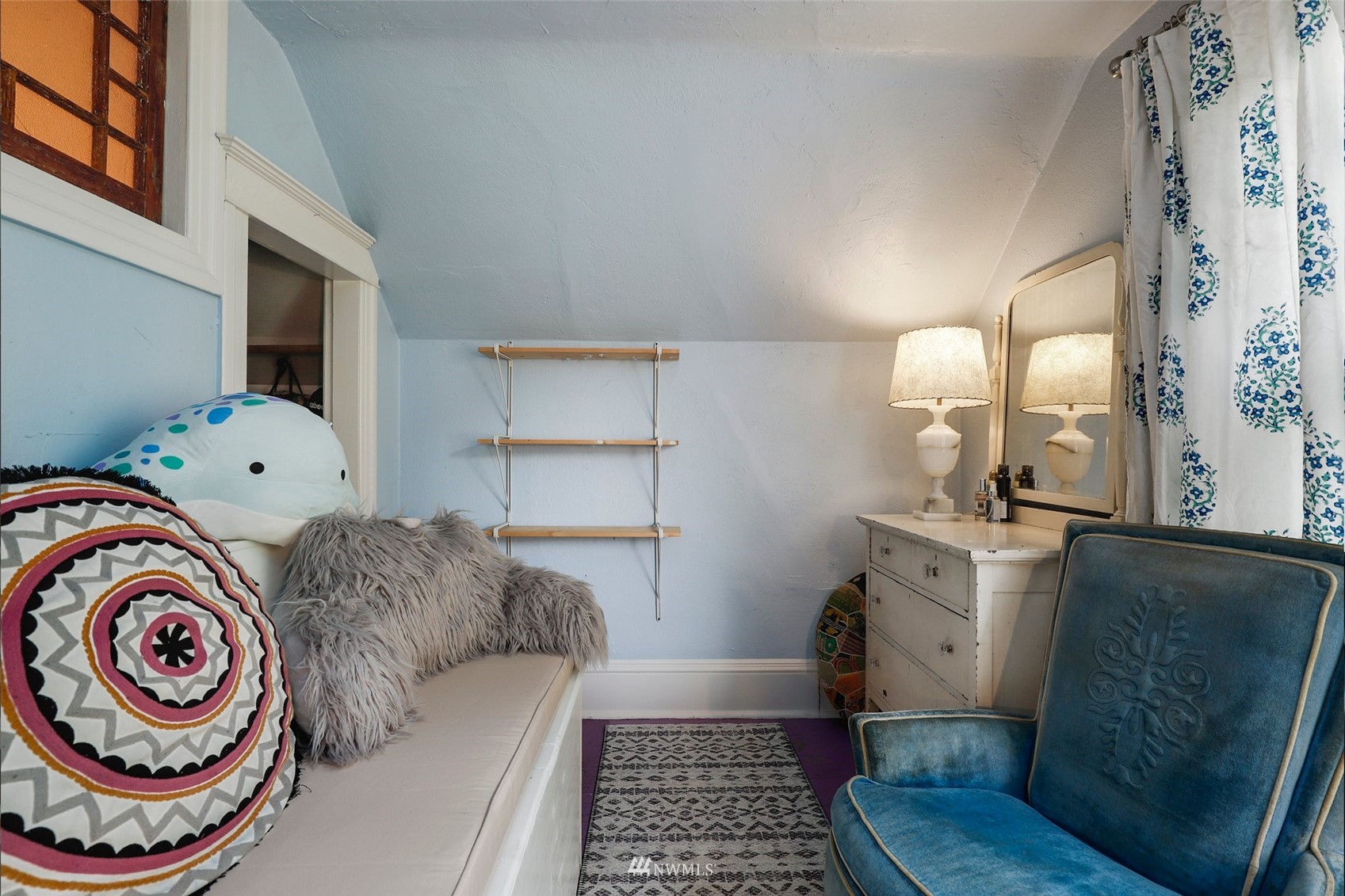1010 South Director Street Seattle, WA 98108 - Photo 24 of 40 a bedroom with a bed and a lamp on the dresser next to a window