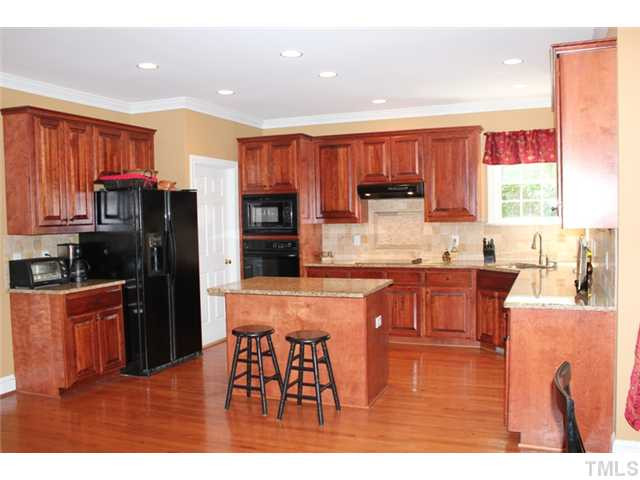5101 Bartons Enclave Lane Raleigh, NC 27613 - Photo 8 of 25 Granite counter tops, center island and backsplash add to the elegance in this Kitchen. Kitchen