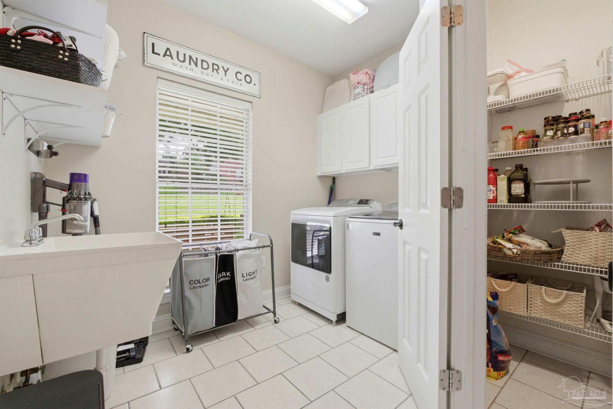 5931 Otter Point Road Pensacola, FL 32504 - Photo 39 of 67 a kitchen with white cabinets and white appliances