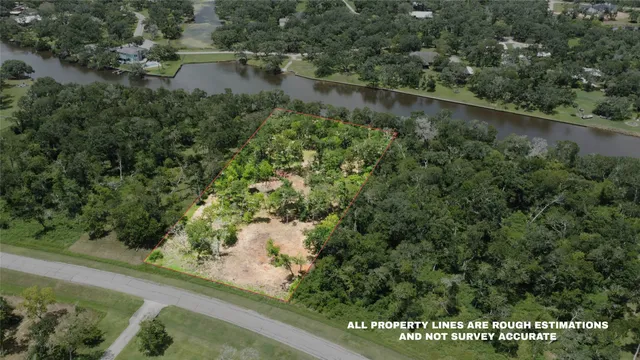 an aerial view of residential house with outdoor space and trees around