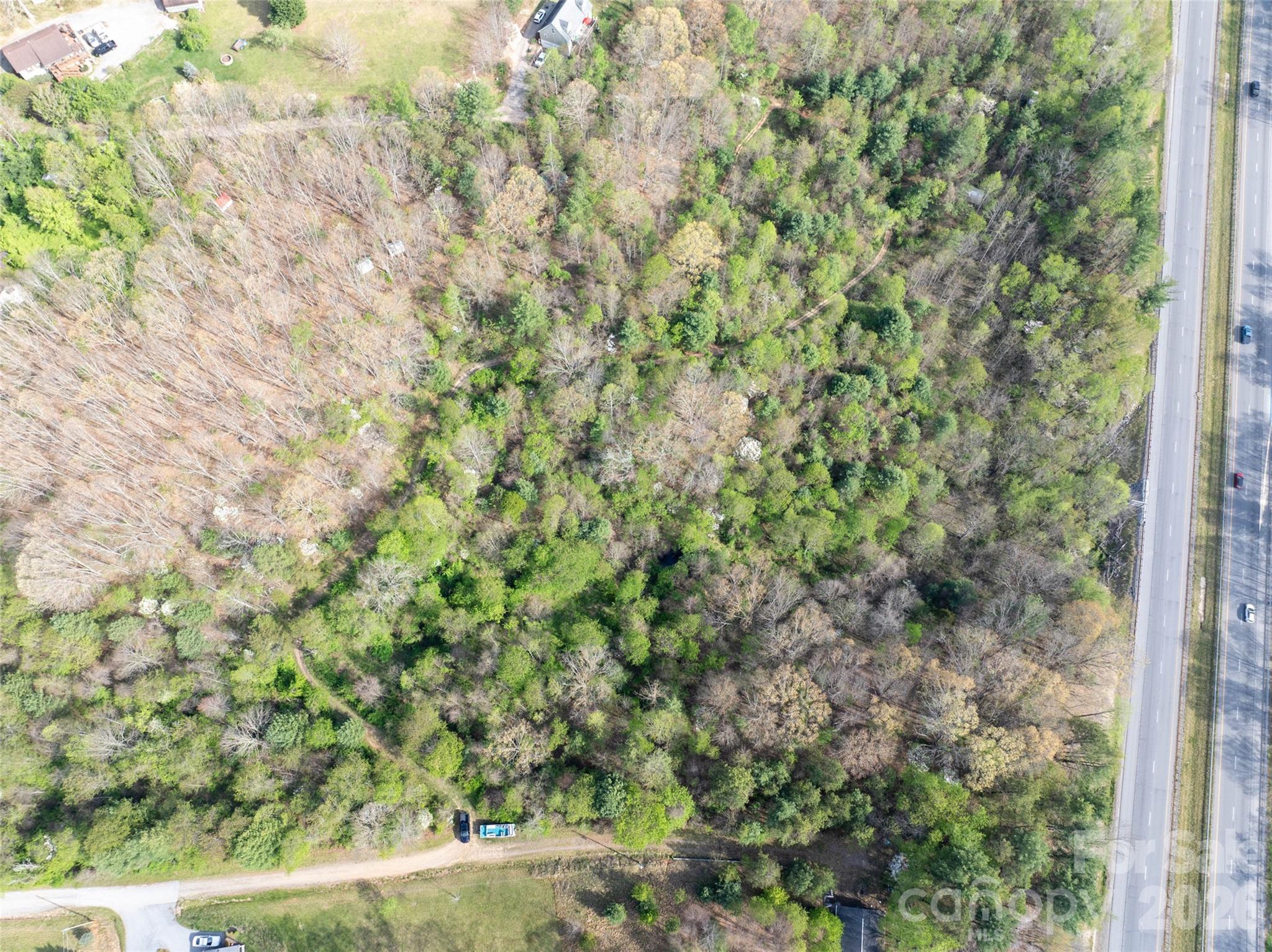 Lot 42 Sunnybrook Trail Clyde, NC 28721 - Photo 10 of 10 a view of a yard with plants and wooden fence