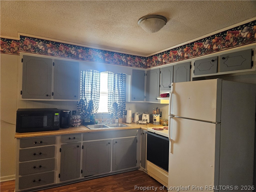 4547 Legion Road Hope Mills, NC 28348 - Photo 11 of 28 a kitchen with refrigerator cabinets and a sink