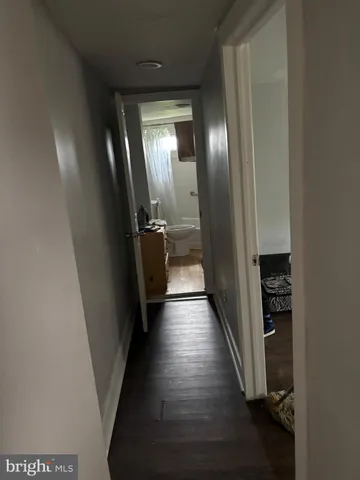 an empty room with wooden closet and windows