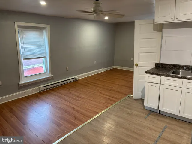 a kitchen with white cabinets and white appliances