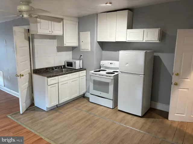 a white toilet sitting next to a sink