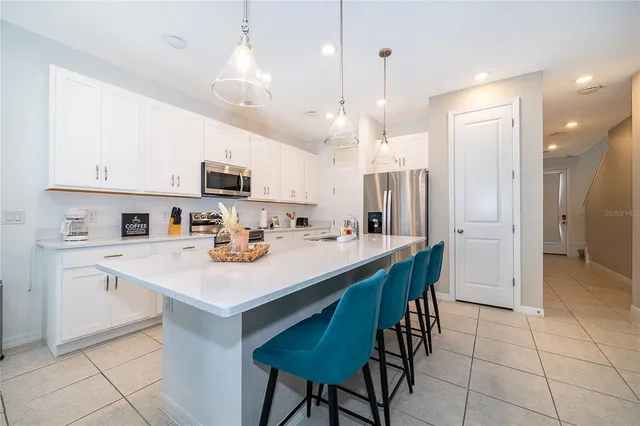 a kitchen with kitchen island appliances cabinets and furniture
