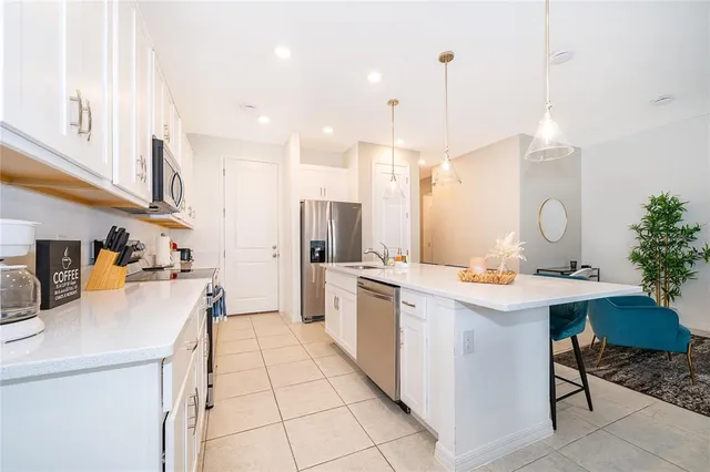 a kitchen with a sink a stove a refrigerator and cabinets