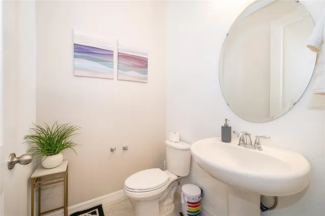 a bathroom with a sink toilet and a mirror