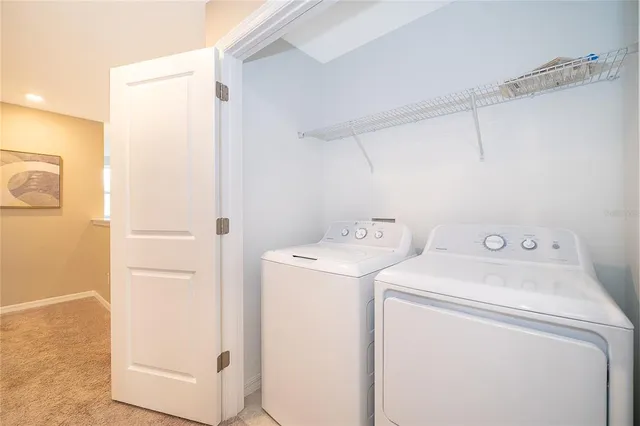 a view of storage and utility room with washer and dryer