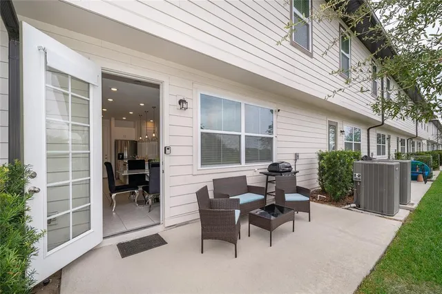 a view of a patio with table and chairs and wooden fence