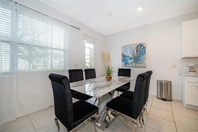 a view of a dining room with furniture and a large window