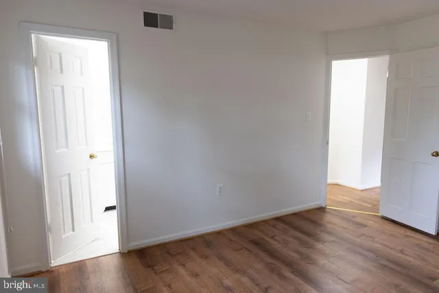 a view of a livingroom with wooden floor and stairs