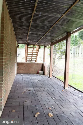 a view of a house with a yard and large trees