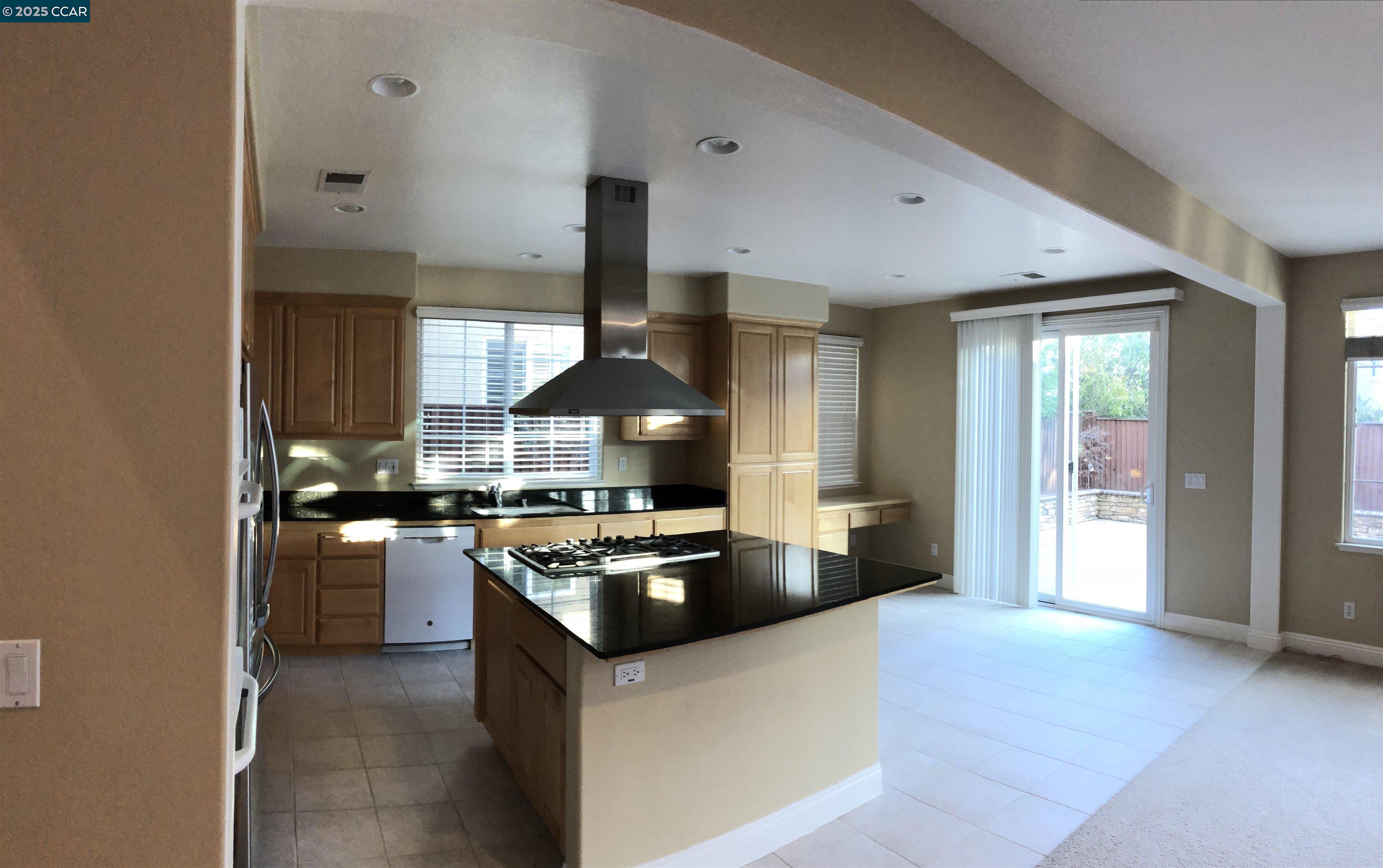 a kitchen with stainless steel appliances granite countertop a stove and a sink
