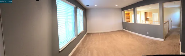 a view of an empty room and a window