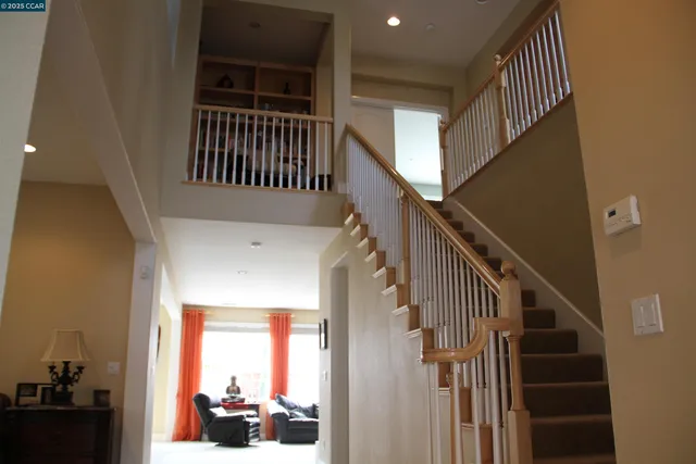 a view of entryway with wooden floor and a front door