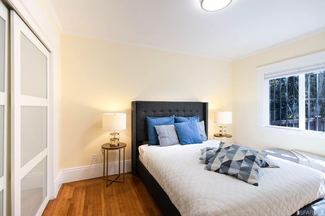 a bed sitting in a bedroom next to a window