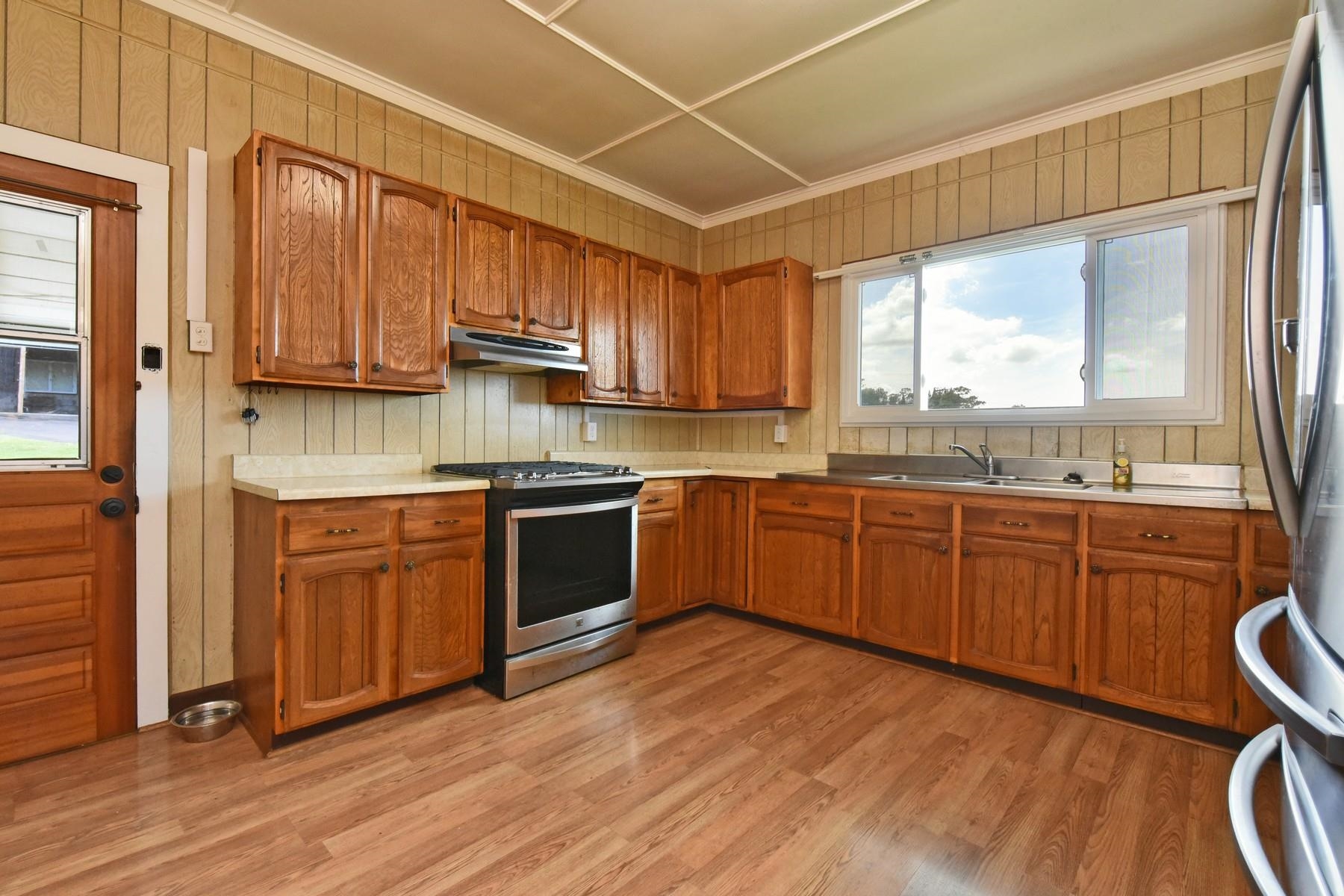 1145 Olinda Road Makawao, HI 96768 - Photo 12 of 30 a kitchen with stainless steel appliances granite countertop wooden cabinets a window and a sink
