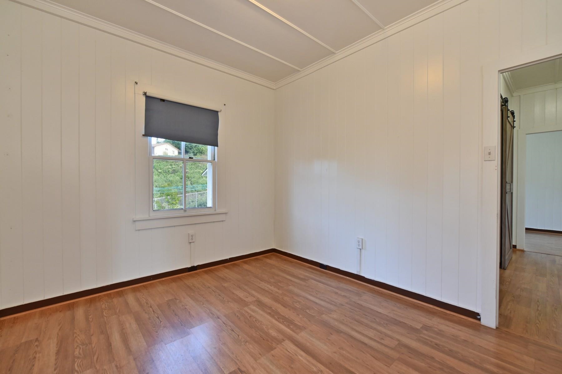 1145 Olinda Road Makawao, HI 96768 - Photo 16 of 30 an empty room with wooden floor and windows