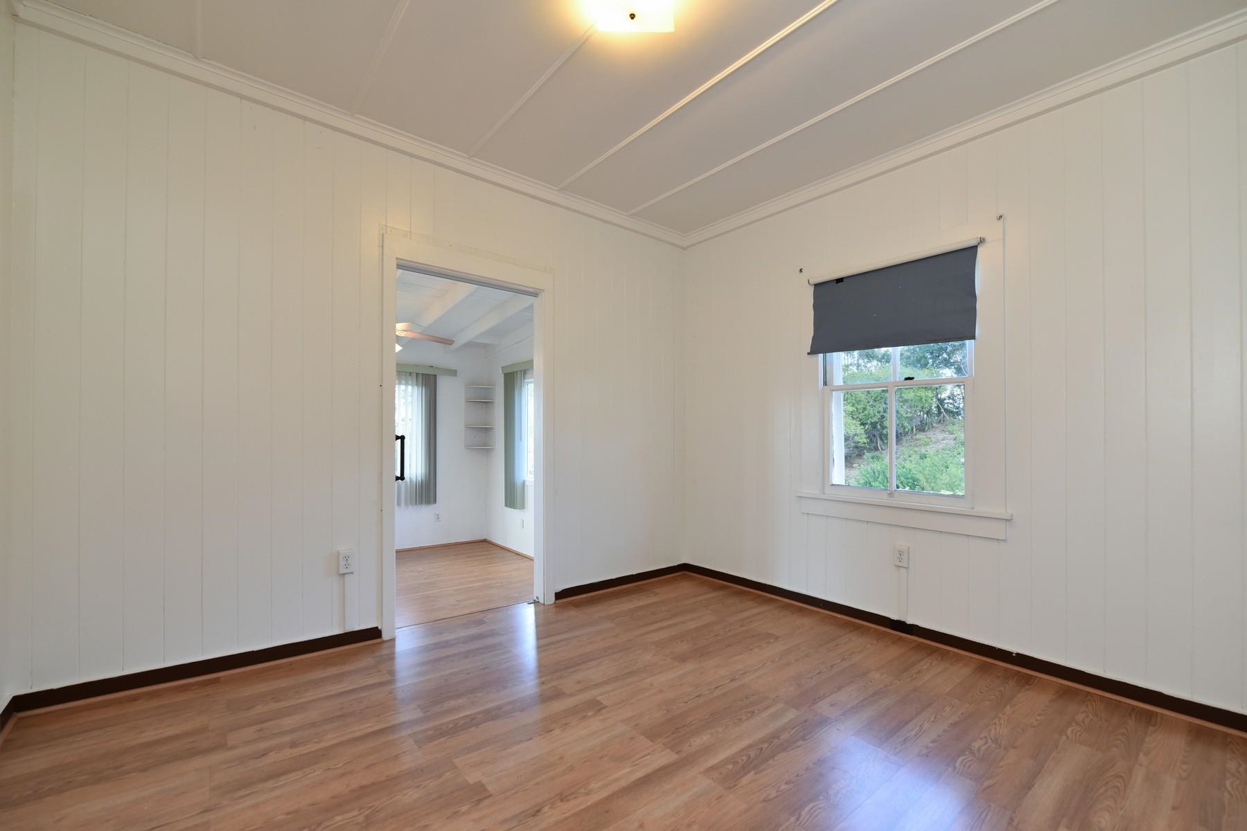 1145 Olinda Road Makawao, HI 96768 - Photo 17 of 30 an empty room with wooden floor and windows