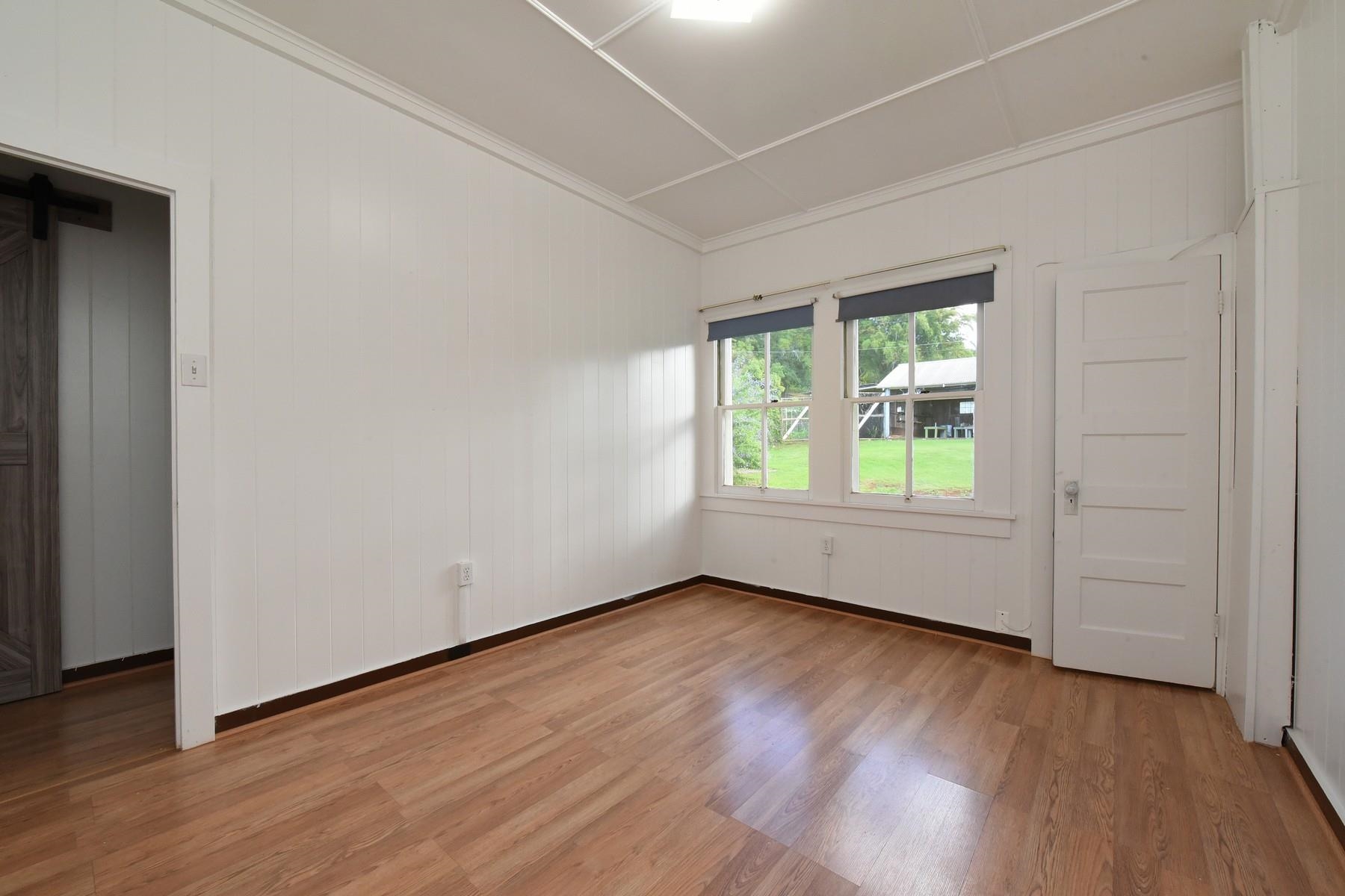 1145 Olinda Road Makawao, HI 96768 - Photo 21 of 30 an empty room with wooden floor and windows