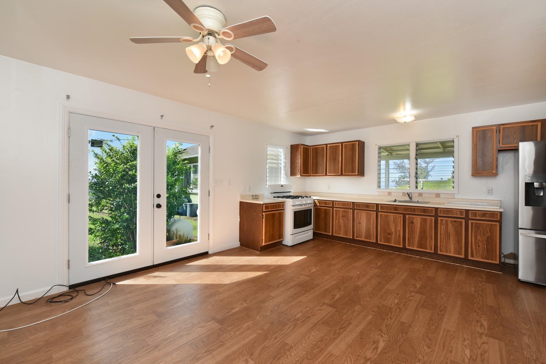 1145 Olinda Road Makawao, HI 96768 - Photo 25 of 30 a large white kitchen with a large window a sink and stainless steel appliances