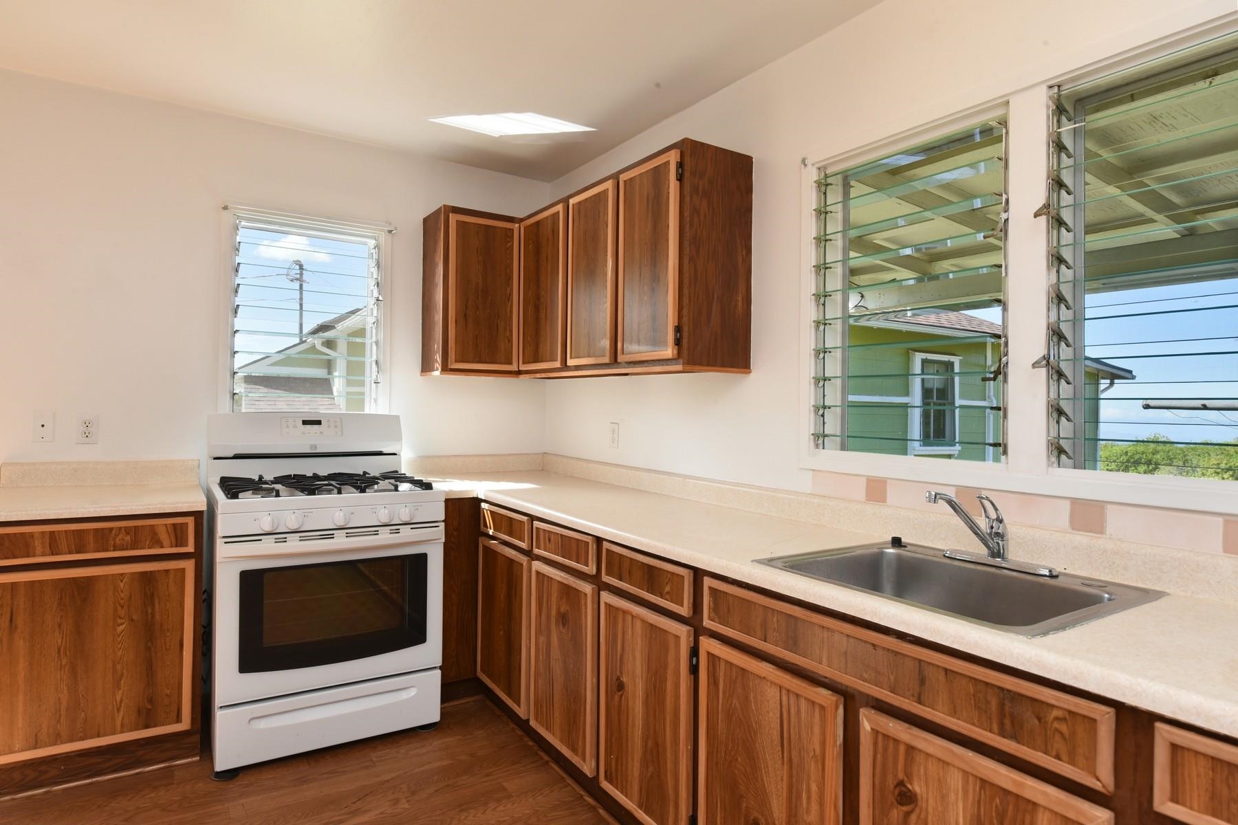 1145 Olinda Road Makawao, HI 96768 - Photo 26 of 30 a kitchen with a sink stove top oven and cabinets