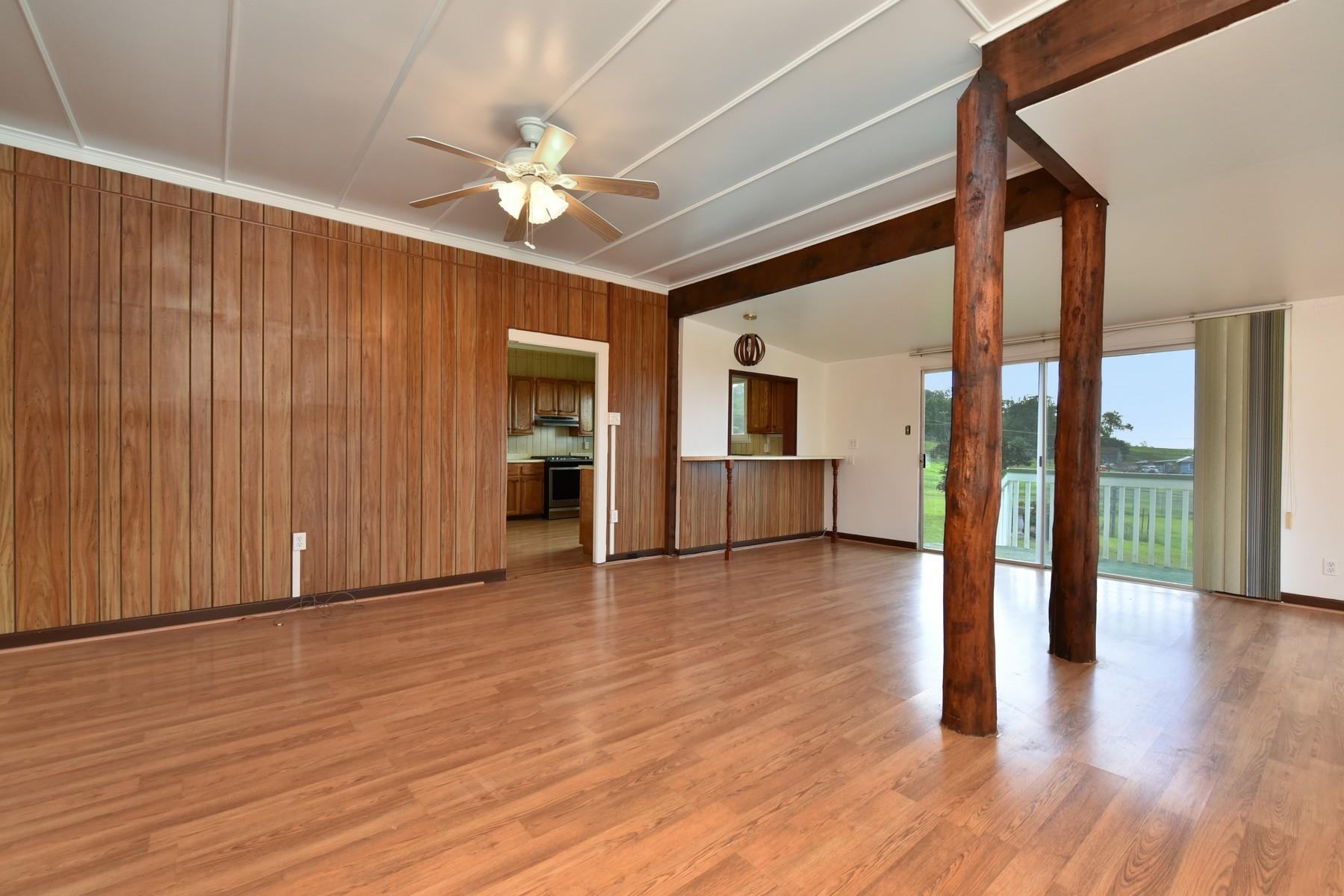 1145 Olinda Road Makawao, HI 96768 - Photo 10 of 30 a view of an empty room with wooden floor and a kitchen