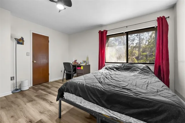 a bed sitting in a bedroom next to a window